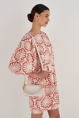 Profile view of model wearing the Oroton Liv Small Day Bag in Paper White and Pebble leather for Women
