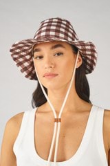 Profile view of model wearing the Oroton Boyd Printed Hat in Gingham and Canvas for Women