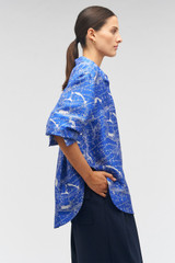 Profile view of model wearing the Oroton Long Sleeve Map Print Camp Shirt in Indigo and 100% silk for Women