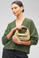 Profile view of model wearing the Oroton Clara Mini Bag in Gold and Metallic crinkle leather for Women