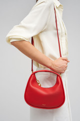 Profile view of model wearing the Oroton Clara Smooth Mini Bag in Dark Poppy and Smooth Leather Exterior for Women