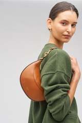 Profile view of model wearing the Oroton Florence Small Shoulder Bag in Cognac and Smooth leather for Women