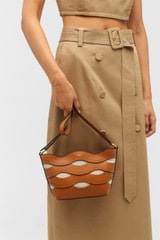 Profile view of model wearing the Oroton Leigh Ric Rac Crossbody in Amber and Smooth leather for Women