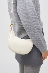 Profile view of model wearing the Oroton Florence Small Shoulder Bag in Clotted Cream and Smooth leather for Women