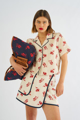Profile view of model wearing the Oroton Crop Dutch Tulip Camp Shirt in Ecru and 100% linen for Women