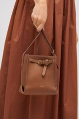 Profile view of model wearing the Oroton Margot Tiny Bucket Bag in Whiskey and Smooth leather for Women