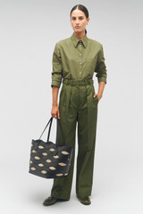 Profile view of model wearing the Oroton Leigh Ric Rac Medium Tote in Black and Smooth leather for Women