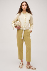 Profile view of model wearing the  Hazel Ruffle Blouse in Vanilla Crème and Made from 100% poplin cotton  for Men