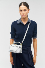 Profile view of model wearing the Oroton Mica Mini Bowler in Mist and Pebble leather for Women