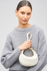 Profile view of model wearing the Oroton Florence Small Shoulder Bag in Clotted Cream and Smooth leather for Women