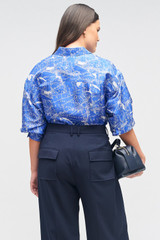 Profile view of model wearing the Oroton Long Sleeve Map Print Camp Shirt in Indigo and 100% silk for Women