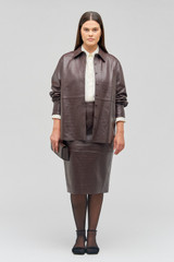 Profile view of model wearing the Oroton Embossed Croc Long Sleeve Overshirt in Burgundy and 100% leather for Women