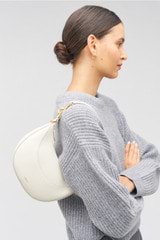 Profile view of model wearing the Oroton Florence Small Shoulder Bag in Clotted Cream and Smooth leather for Women