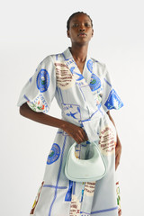 Profile view of model wearing the Oroton Picnic Print Dress in Pale Blue and 100% silk for Women