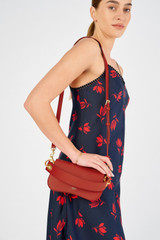 Profile view of model wearing the Oroton Liv Small Day Bag in Dark Poppy and Pebble leather for Women