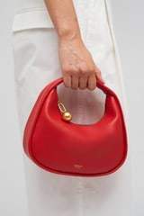 Profile view of model wearing the Oroton Clara Smooth Mini Bag in Dark Poppy and Smooth Leather Exterior for Women