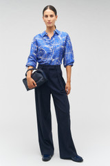 Profile view of model wearing the Oroton Long Sleeve Map Print Camp Shirt in Indigo and 100% silk for Women